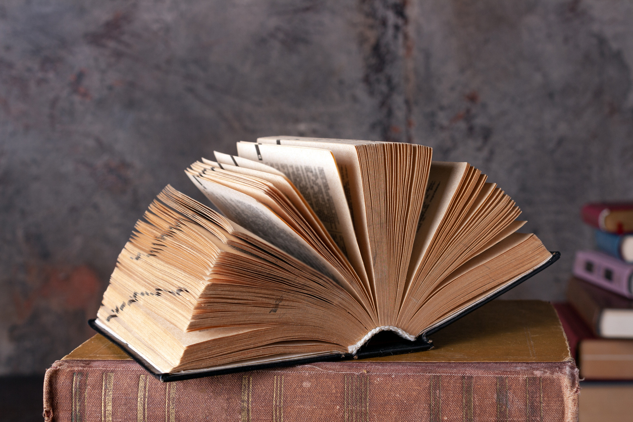 open dictionary, hardcover, lying on books, close up