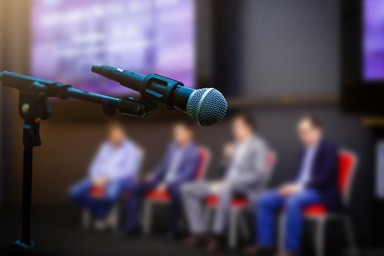 microphone in front businesspeople blurred in conference meeting room